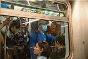  ?? EMON HASSAN / NYT ?? A masked rider on a subway train at Union Square in Manhattan on May 11, 2023. A COVID variant called KP.2 might be more contagious than its predecesso­r, but an updated vaccine offers protection.