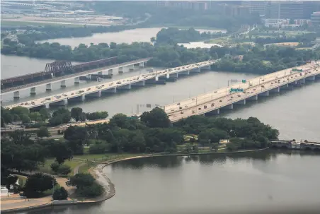  ?? Stefani Reynolds / Getty Images ?? Vehicles cross Potomac River bridges in Washington. Funding for roads and bridges is among the items lawmakers are debating.