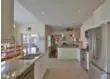  ??  ?? An L-shaped counter serves as a breakfast bar in the kitchen.