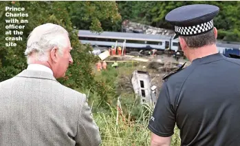  ?? Picture: BEN BIRCHALL/PA ?? Prince Charles with an officer at the crash site