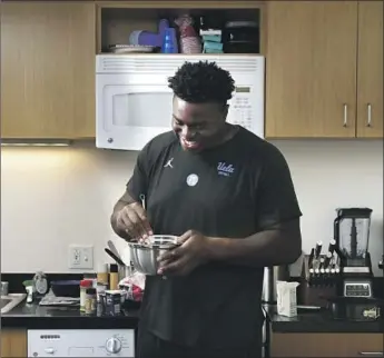  ?? Photograph­s by Christina House Los Angeles Times ?? FEW THINGS make UCLA defensive lineman Otito Ogbonnia smile more than when he’s in the kitchen making some of his favorite culinary dishes, especially when it’s a Thanksgivi­ng feast for his teammates.