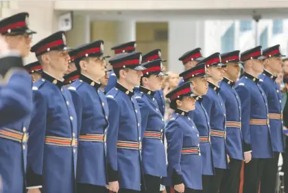  ?? IAN KUCERAK ?? Officers with Edmonton Police Service Recruit Training Class No. 153 stand side by side during their graduation ceremony at City Hall Friday. It is the first such public ceremony to be held since the beginning of the COVID-19 pandemic.