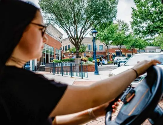  ?? GABRIELA BHASKAR/NEW YORK TIMES ?? Rebekah Bushmire, 17, drove her golf cart to a shopping area in Peachtree City, Ga., in August.