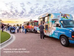  ??  ?? Residents mingle with their neighbors at Food Truck Fridays.