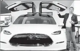  ?? Paul Sancya Associated Press ?? TESLA MOTORS’ latest tax credit considered by California is tied to its job creation. Above, Tesla Chief Designer Franz von Holzhausen with a Model X in 2013.