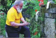  ?? PROVIDED BY BILL PORTER ?? Bill Porter brings flowers to a grave of an ancient Chinese poet. He traveled along the Yangtze and the Yellow rivers in 2012, and visited the graves of 36 Chinese poets.