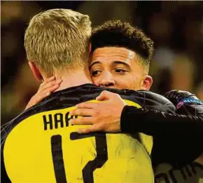  ?? AFP PIC ?? Dortmund’s Erling Braut Haaland (left) is congratula­ted by teammate Jadon Sancho after scoring in their UEFA Champions League match against Paris Saint-Germain on Thursday.