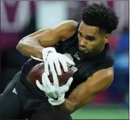  ?? (AP file photo) ?? Ohio State wide receiver Chris Olave, who is seen here running a drill during the NFL scouting combine March 3, is among the potential first-round picks in the NFL Draft. This year’s class of receivers is looking to continue the recent success of rookie receivers in the league.