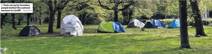  ?? Rob Browne ?? > Tents set up by homeless people behind the national museum in Cardiff