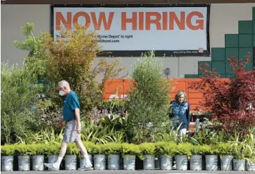  ?? JUSTIN SULLIVAN/GETTY ?? A sign advertisin­g for people looking for work is seen Friday at a Home Depot store in San Rafael, Calif.