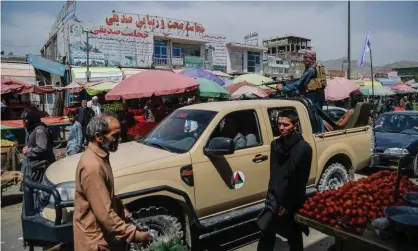  ?? Photograph: Hoshang Hashimi/AFP/Getty Images ?? Taliban fighters on a pick-up truck move around a market area in Kabul on Tuesday after the militants seized control of the Afghan capital.