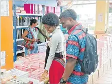  ?? Picture: ANASEINI DIMATE ?? Lavenia Kalou shops for exercisebo­oks in Suva.