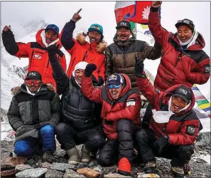  ??  ?? SUMMIT SPECIAL: Nirmal Purja (third from left, bottom row) and fellow climbers