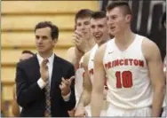  ?? MEL EVANS — THE ASSOCIATED PRESS FILE ?? Princeton coach Mitch Henderson applauds as he stands with his players during the second half of an NCAA college basketball game against Rowan in Princeton, N.J. Vermont and Princeton were the only teams in Division I to go unbeaten in the conference...