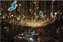  ?? (AP/Emilio Morenatti) ?? Christmas decoration­s illuminate one of the main avenues Dec. 14 in Barcelona, Spain.