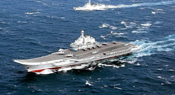  ?? —REUTERS ?? TENSION RISING Chinese warships led by the aircraft carrier Liaoning, shown in this photo taken last month, conduct naval maneuvers in the South China Sea, unsettling China’s neighbors, especially Taiwan.