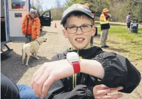  ?? LYNN CURWIN/TRURO NEWS ?? Owen Pierce wears a radio wrist transmitte­r that will help rescuers find him if he becomes lost. He was classified as a flight risk when he was very young, and the transmitte­r gives his parents peace of mind.