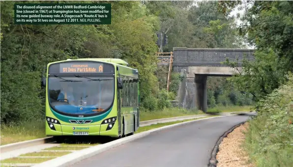  ?? NEIL PULLING. ?? The disused alignment of the LNWR Bedford-Cambridge line (closed in 1967) at Trumpingto­n has been modified for its new guided busway role. A Stagecoach ‘Route A’ bus is on its way to St Ives on August 12 2011.
