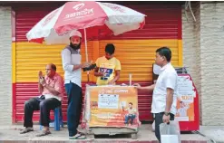  ??  ?? DHAKA: In this Wednesday, Oct 26, 2016 photo, a Bangladesh­i recharges his mobile phone balance at a roadside Airtel center. —AP