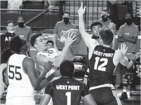  ?? PAUL W. GILLESPIE/CAPITAL GAZETTE ?? Navy’s Greg Summers pulls in an offensive rebound in the first half against Army at Alumni Hall on Saturday in Annapolis.