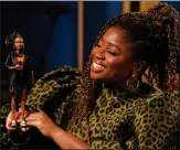  ??  ?? Radio 1 DJ Clara Amfo holds a Barbie doll created in her likeness ahead of Internatio­nal Women’s Day