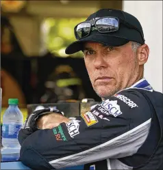  ?? DARRON CUMMINGS/ASSOCIATED PRESS ?? Kevin Harvick waits in his garage before practice for a NASCAR Cup Series race at Indianapol­is Motor Speedway in August. He’s in ninth place, which is one spot below the cut line.