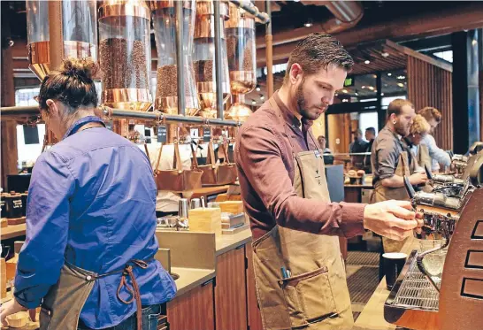  ?? Photo: REUTERS ?? Starbucks workers crank out the coffee for customers who give away plenty about themselves by what they order.