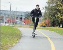  ?? DAVID BEBEE WATERLOO REGION RECORD ?? University of Waterloo student Alex Jabbour uses a Lime e-scooter on a trail near the University of Waterloo on Friday.