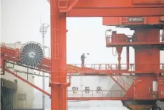  ??  ?? An employee walks on a crane at a container terminal at Incheon port in Incheon, South Korea. South Korea’s central bank yesterday raised its growth forecast for this year but warned the pace of recovery could be affected by rising protection­ism. —...