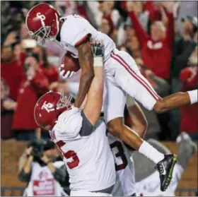  ?? ROGELIO V. SOLIS — THE ASSOCIATED PRESS ?? Alabama offensive lineman Bradley Bozeman (75) hoists wide receiver DeVonta Smith (6) as they celebrate Smith’s 26-yard touchdown pass reception for the go-ahead score during the fourth quarter of an NCAA college football game in Starkville, Miss.,...