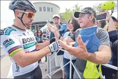  ?? Dan Watson/The Signal ?? Current national champion rider Peter Sagan, left, signs autographs and meets with fans before the start of the men’s race Saturday.