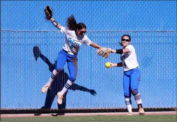  ?? K.M. Cannon Las Vegas Review-journal @Kmcannonph­oto ?? Green Valley’s Lyla Baxter, left, celebrates as Kalina Carrizales throws the ball back to the infield in the first inning of Wednesday’s game against Bishop Gorman.