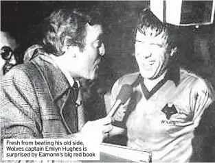  ?? ?? Fresh from beating his old side, Wolves captain Emlyn Hughes is surprised by Eamonn’s big red book