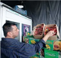  ?? (Khalid al-Mousily/Reuters) ?? A VENDOR stands with his dates in Baghdad earlier this year. Some blame the Iranian protests on the country’s bad economy.