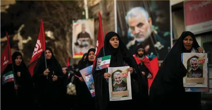  ?? ALI MOHAMMADI/BLOOMBERG ?? Mourners carrying images of Iranian General Qassem Soleimani during a funeral ceremony in Tehran, Iran, on Monday, Jan 6