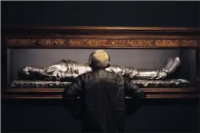  ?? (AP/Godofredo A. Vasquez) ?? A man looks March 24 at a bronze sculpture by Kehinde Wiley titled “The Body of the Dead Christ in the Tomb” at the de Young Museum.