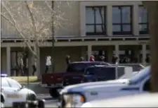  ?? JON AUSTRIA — THE DAILY TIMES VIA AP ?? Students are led out of Aztec High School after a shooting Thursday in Aztec, N.M. The school is in the Four Corners region and is near the Navajo Nation.