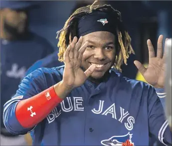  ?? Fred Thornhill Associated Press ?? VLADIMIR GUERRERO JR., who made his major league debut Friday night for Toronto, smiles during Saturday’s game. Guerrero has a double and a single in his first two game with the Blue Jays.