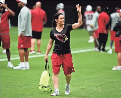  ??  ?? Former Arizona Cardinals assistant coaching intern Jen Welter waves to fans during a 2015 training camp practice in Glendale. Welter was the first woman to coach in the NFL.