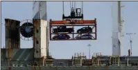  ?? The Associated Press ?? TRADE GAP: A crane transporti­ng vehicles operates on a container ship at the Port of Oakland, in Oakland, Calif., on July 13. U.S. President Donald Trump and his economic advisers see the country’s trade deficits as a sign of economic weakness. They...