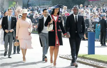  ??  ?? British actor Idris Elba arrives with his fiancée, Sabrina Dhowre, followed by US talkshow host Oprah Winfrey, at yesterday’s royal wedding.