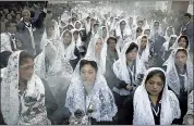  ?? RODRIGO ABD /ASSOCIATED PRESS ?? Women burn incense while participat­ing in a Good Friday procession honoring “The Lord of Miracles”, the patron saint of Lima, Peru.