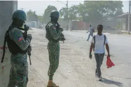  ?? ODELYN JOSEPH/AP ?? Haitian soldiers patrol a road March 13 near the internatio­nal airport in Port-au-Prince. The capital is mostly controlled by armed criminal gangs at this time.