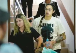  ?? ALEXANDER ZEMLIANICH­ENKO/AP ?? Mercury center Brittney Griner is escorted to a courtroom for a hearing last week outside of Moscow. Griner’s trial is scheduled to resume Thursday.
