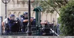  ??  ?? PARIS: French policemen point their weapons near the site of an attack at the entrance of Notre-Dame cathedral on Tuesday. — AFP