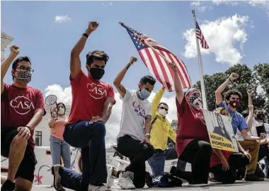  ?? Bloomberg file photo ?? Demonstrat­ors kneel outside the U.S. Supreme Court on June 18, when it blocked President Donald Trump from ending the Deferred Action for Childhood Arrivals program, which allows young immigrants to work legally in the U.S.