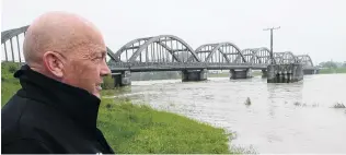  ?? PHOTO: RICHARD DAVISON ?? Under control . . . Clutha Mayor Bryan Cadogan takes stock of the Clutha River as floodwater begins to recede late yesterday.