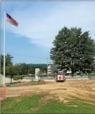  ??  ?? Crew workers are seen performing renovation­s to the area around Van Schaick Island Pond Friday afternoon.