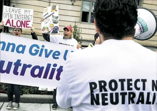  ?? Chip Somodevill­a/Getty Images ?? Supporters of net neutrality protest against FCC chairman Ajit Pai in May in Washington, D.C.