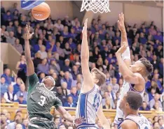  ?? GERRY BROOME/ ASSOCIATED PRESS ?? Colorado State’s Kendle Moore (3) drives to the basket in the face of defensive pressure from Duke’s Joey Baker, center, and Javin DeLaurier, right, during their game Thursday night.